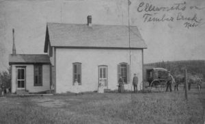 Photo of a white frame house on the plains