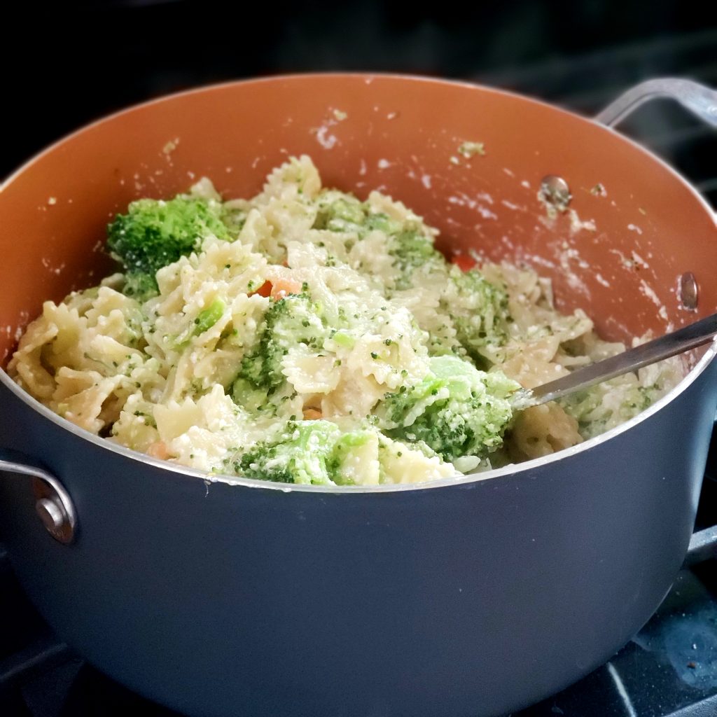 pot with broccoli and tomatoes and pasta