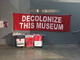 sign saying "decolonize this museum" at the Whitney