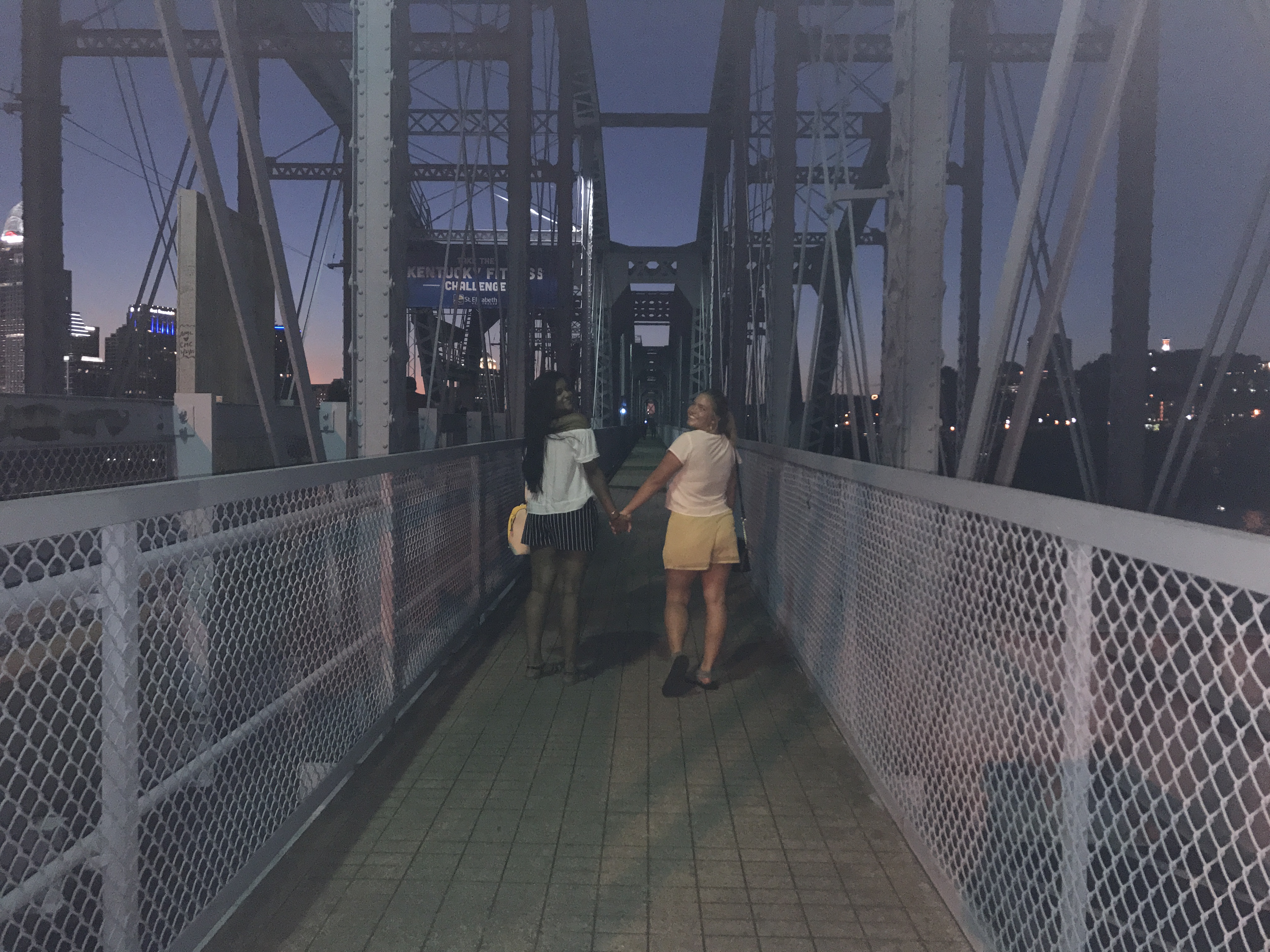 two people on a bridge at night