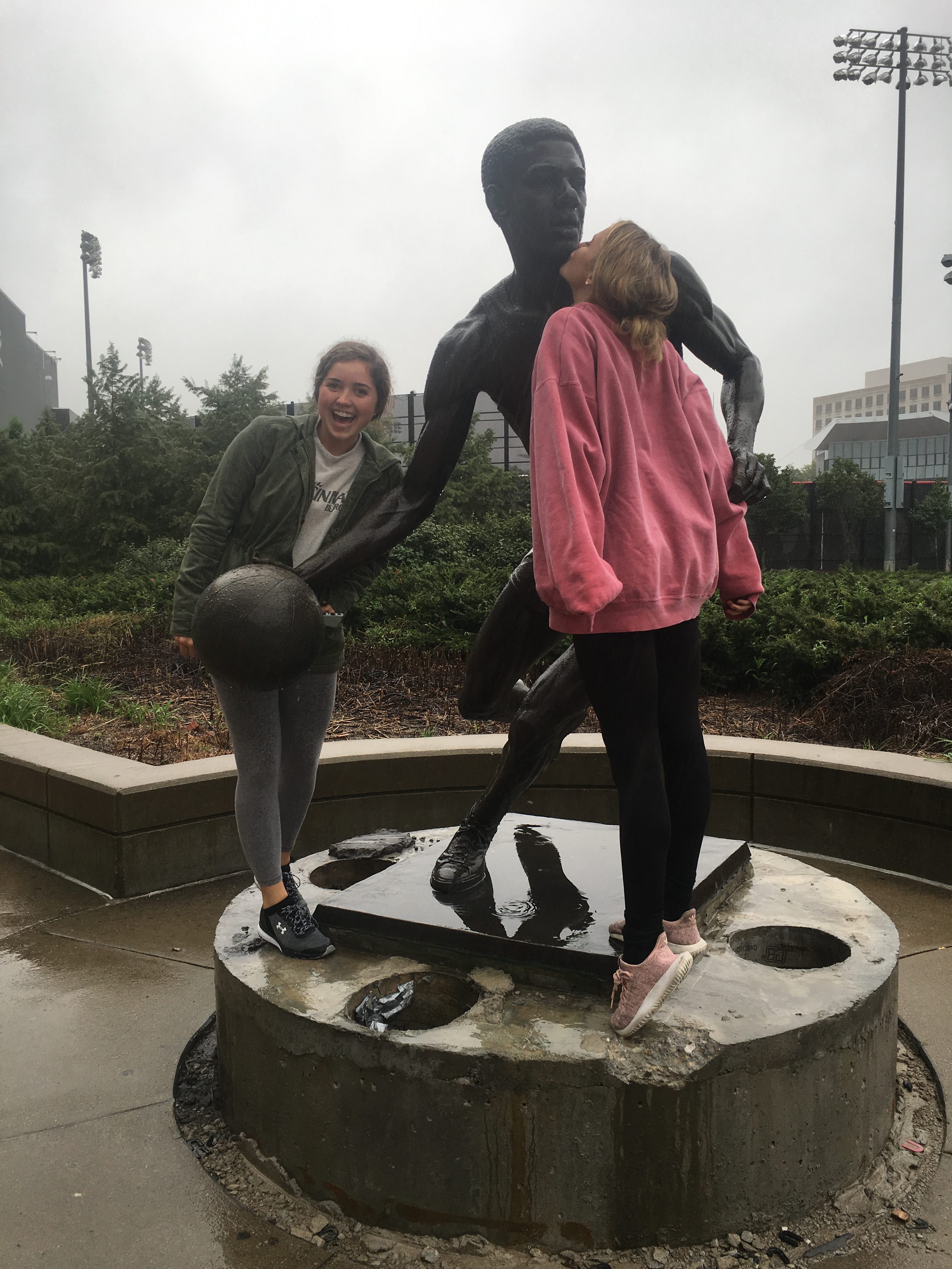 A picture of my two roommates with the Oscar Robertson statue outside of the Fifth Third Arena in its original location.