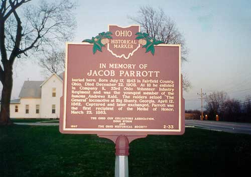 brown state historic marker with large stone house in background
