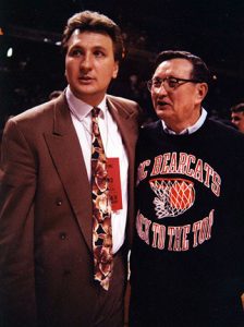Huggins standing with his father