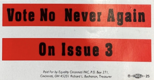 A red and white sticker with black text. The text reads "Vote No Never Again On Issue 3"
