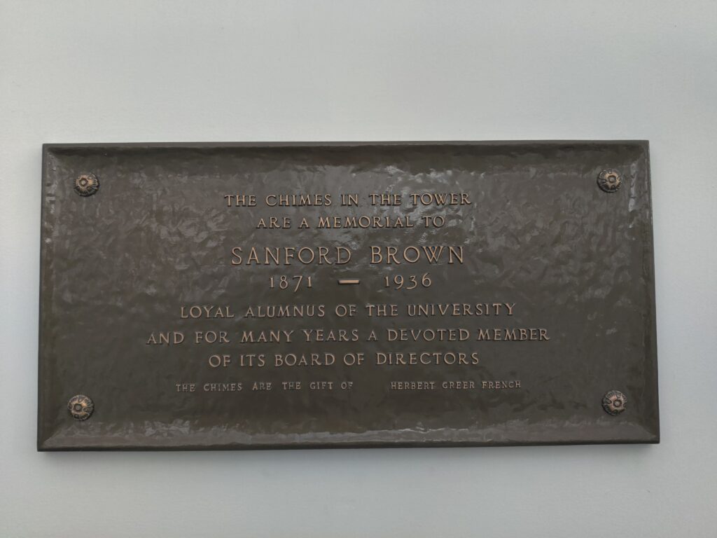 Bronze plaque located on the east entrance facing Bearcats Commons approximately plastered six feet on the interior wall.