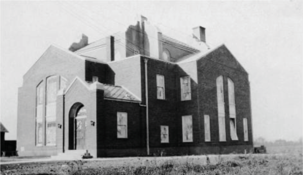 New Cherry Grove United Methodist building in 1925, surrounded by open space and small residential structures.