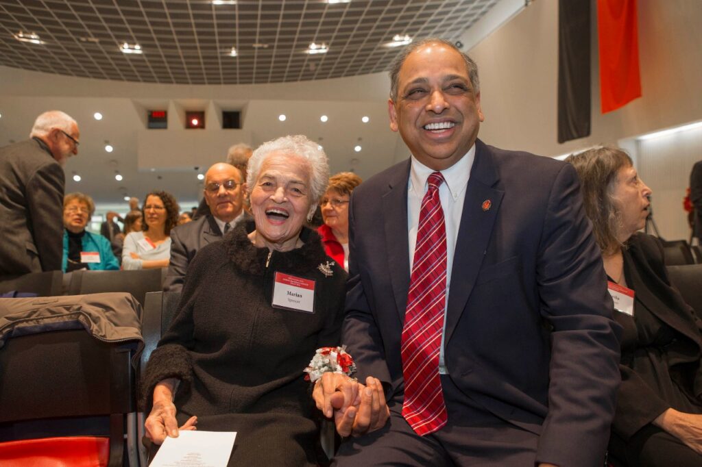a picture of Marian Spencer with University President Pinto sitting 