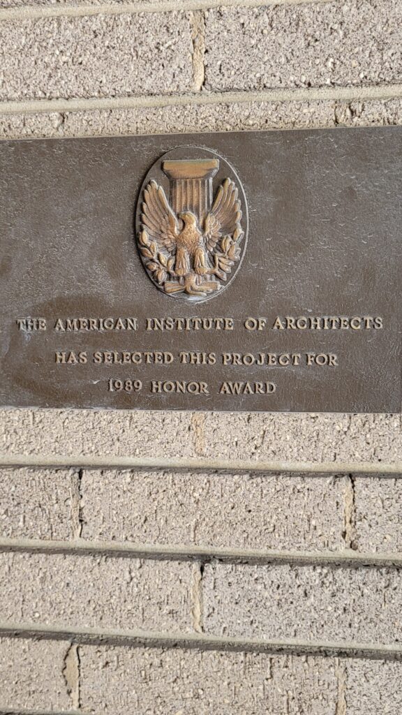 A plaque reading "The American Institute of Architects has selected this project for 1989 Honor Award" accompanied by an eagle medallion.