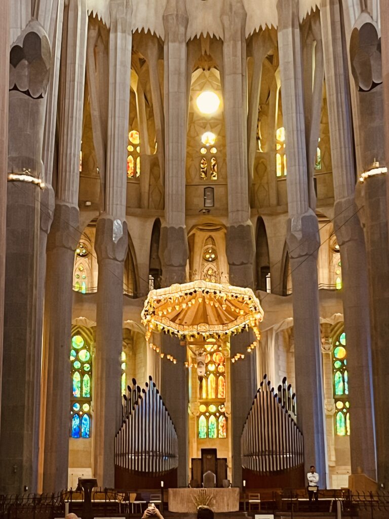 A picture of Jesus hanging from the ceiling above the giant organ