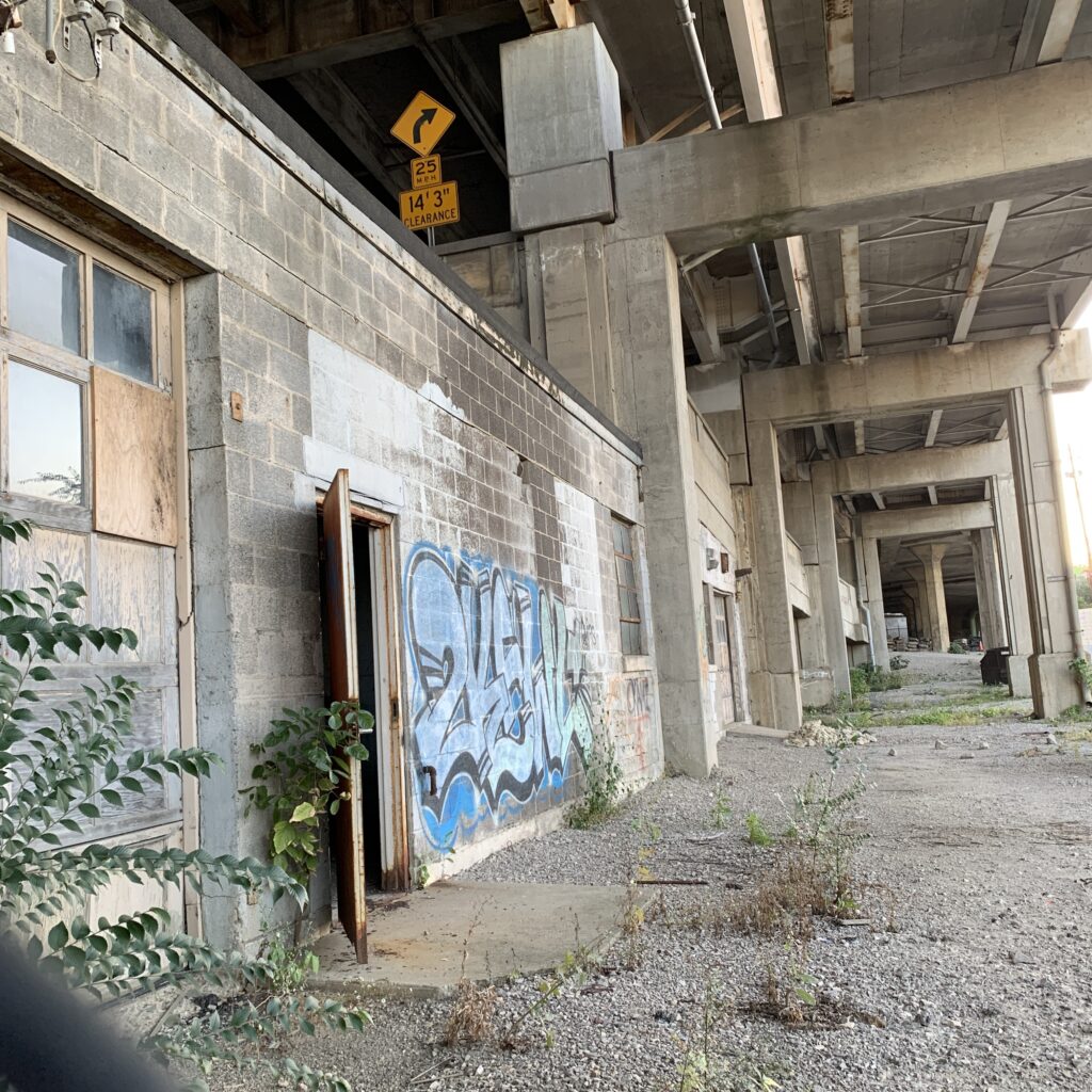 Abandoned streetcar garage and distributor beneath the western terminus of the Western Hills Viaduct, showing advanced signs of decay