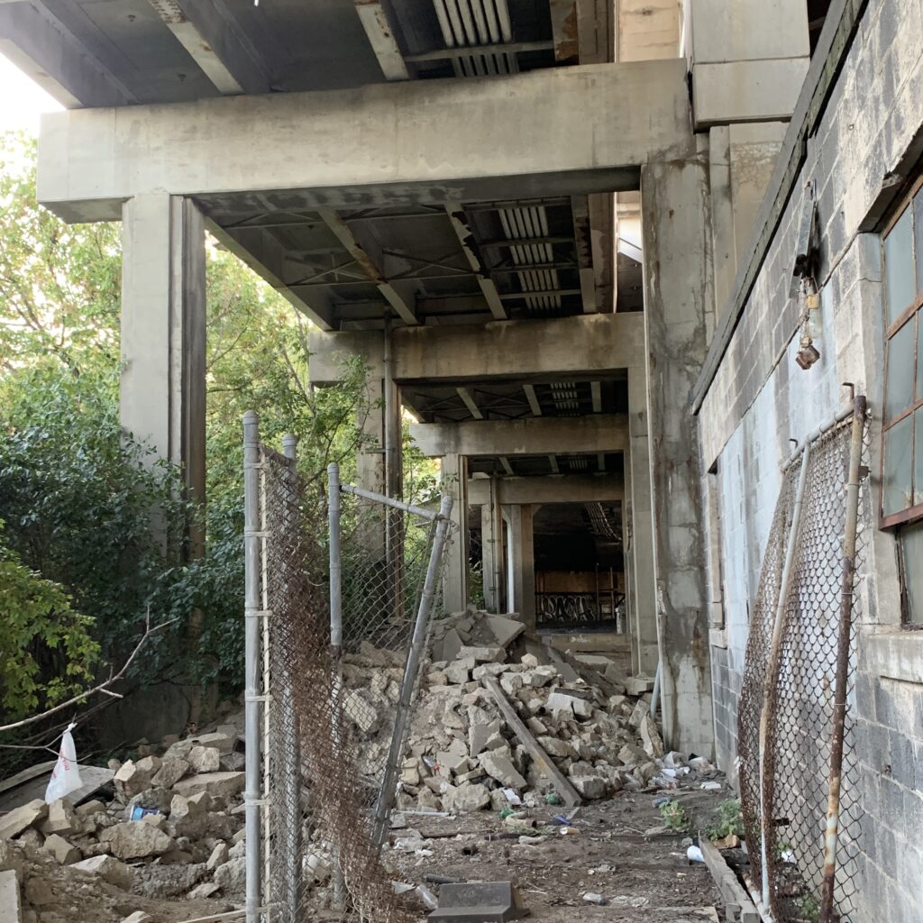 Abandoned streetcar garage and distributor beneath the western terminus of the Western Hills Viaduct, showing advanced signs of decay