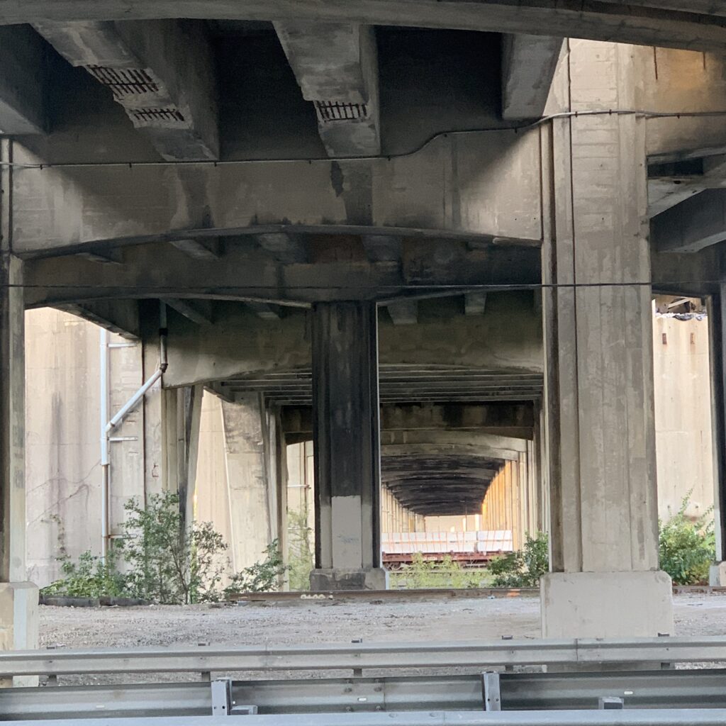 View beneath the viaduct looking across the Camp Washington Rail Yard, showing advanced signs of decay, fall 2023.