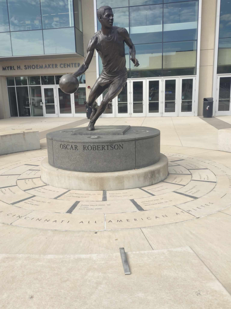 This statue created in the likeness of former Professional Basketball player Oscar Palmer Robertson dribbling a basketball, is proudly displayed in front of the Fifth Third Area on the University of Cincinnati Ohio campus. Robertson himself was a UC Bearcat having attended the University of Cincinnati, where he played on the basketball team from 1957 to 1960.