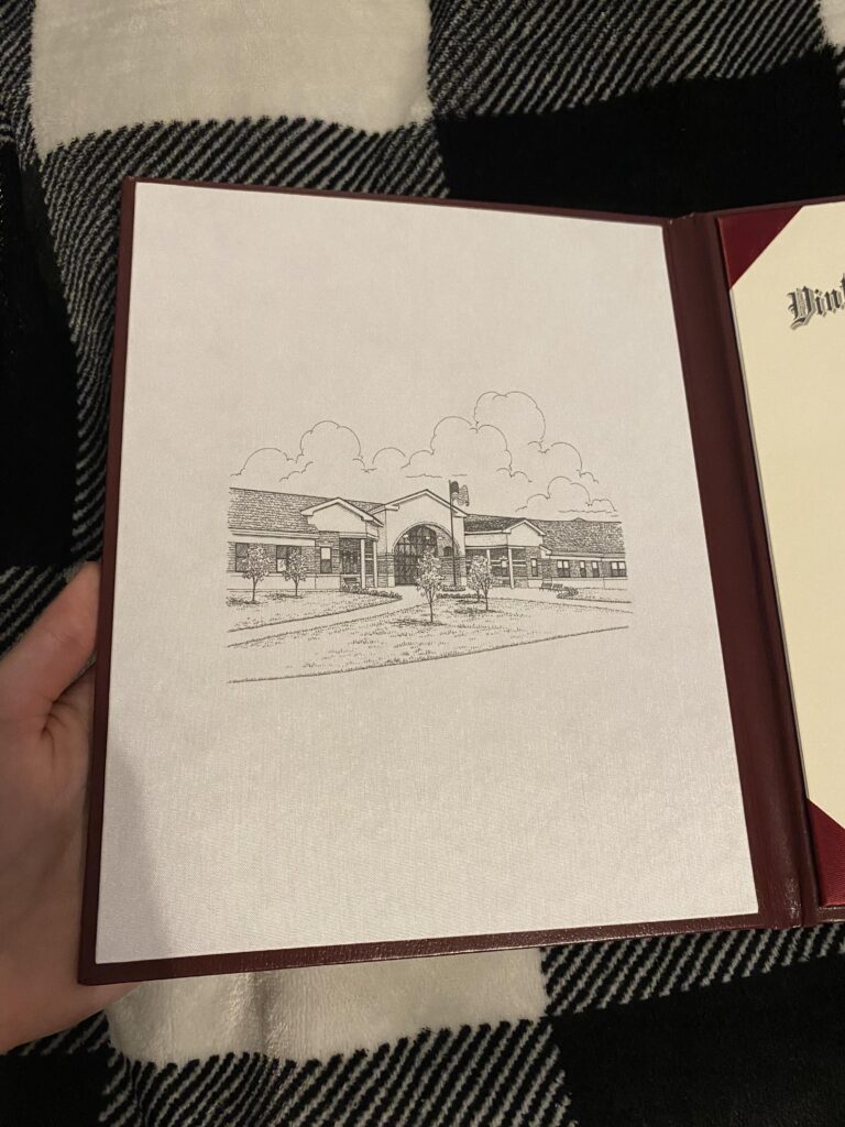inside cover of diploma with sketch of school building