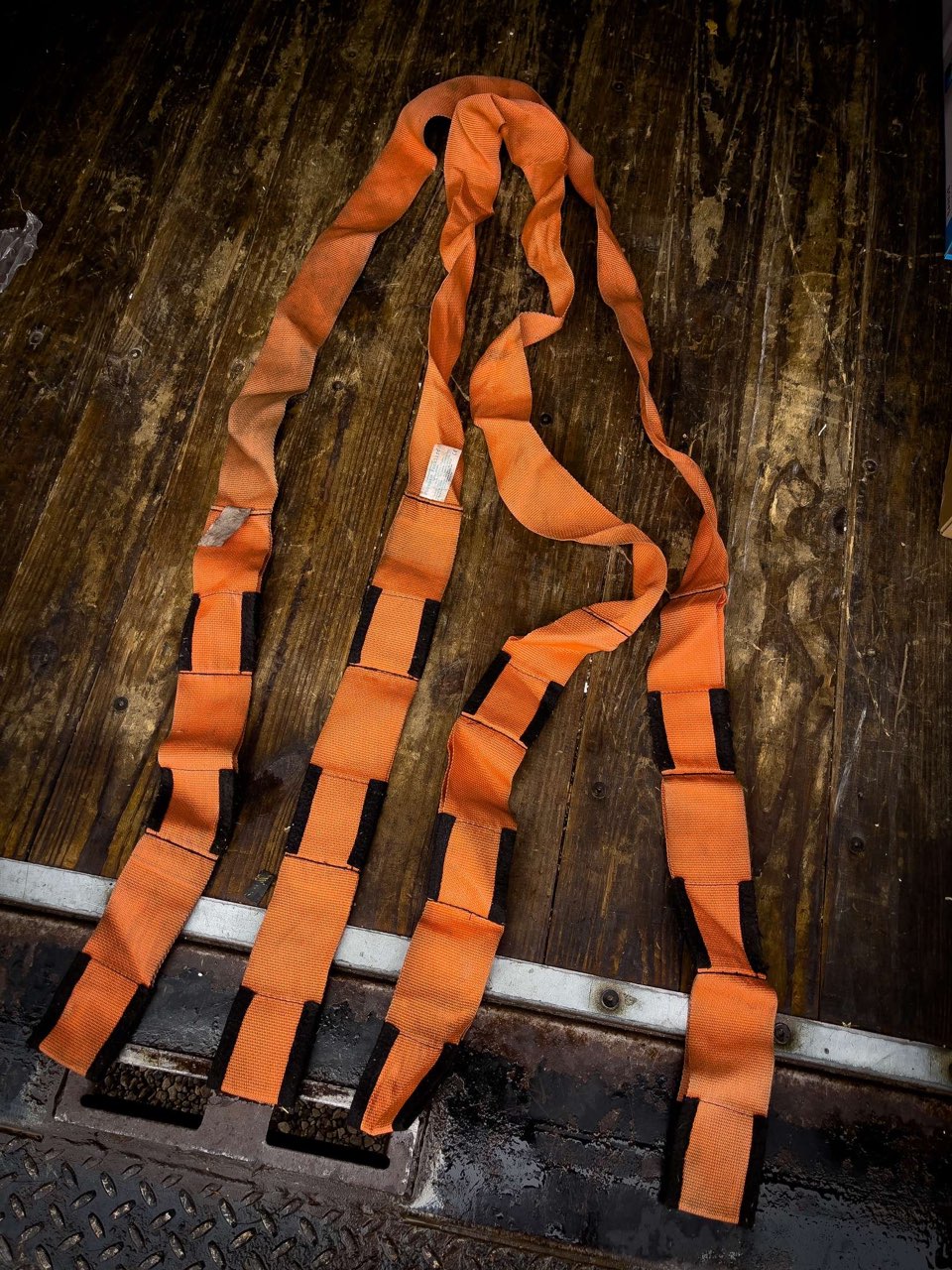 Top-down view of orange cloth forearm straps for one person.