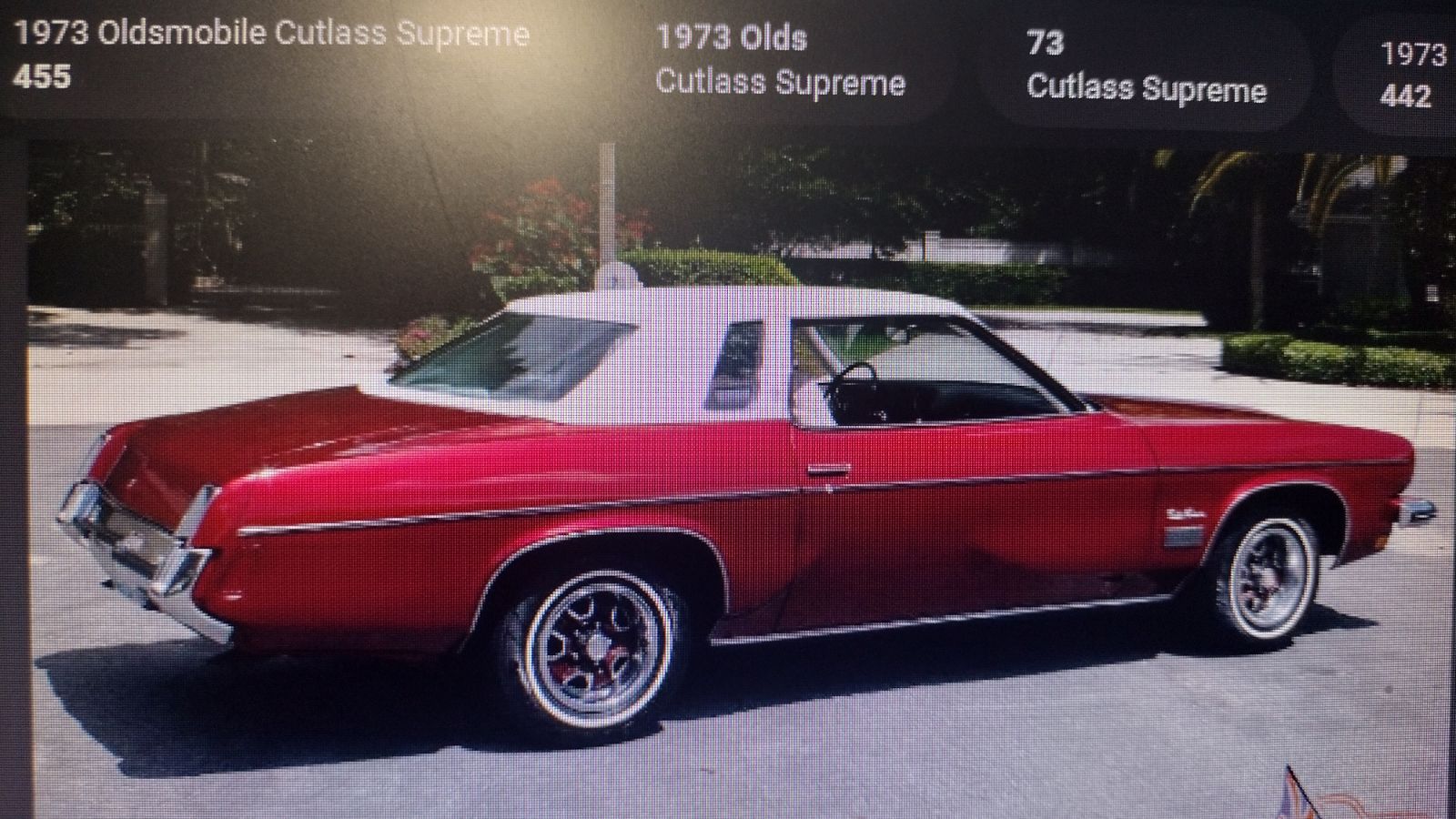 red 1973 oldsmobile cutlass supreme parked on street