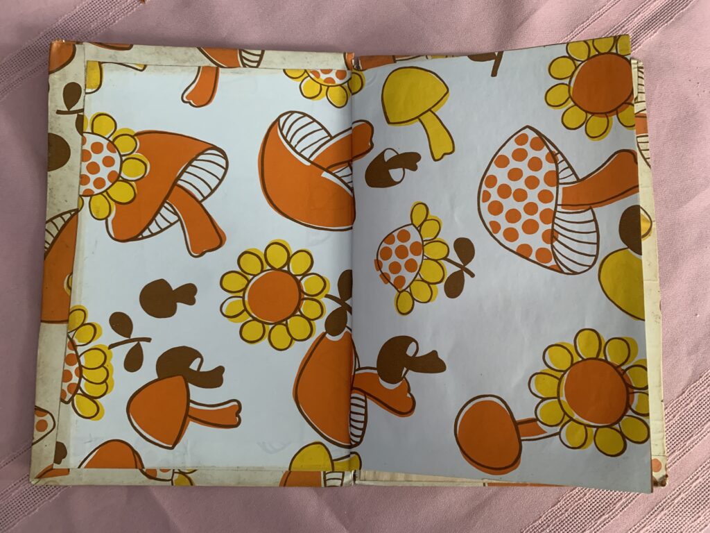 Endsheet of "Elmer the Elephant" constructed of contact paper with 70's sunflower & mushroom design
