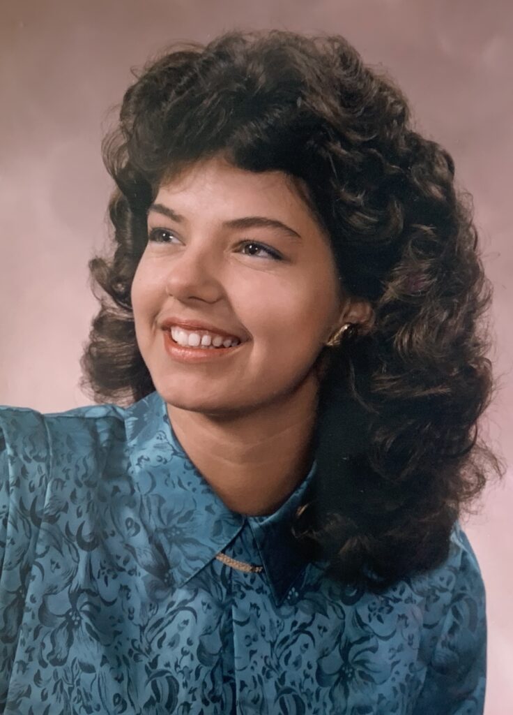 Cusson's senior photo, showing large 80's hairstyle, spring 1987.