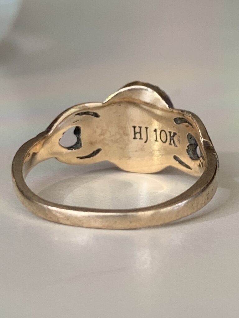 Obverse side of ring, showing maker and 10k markings.