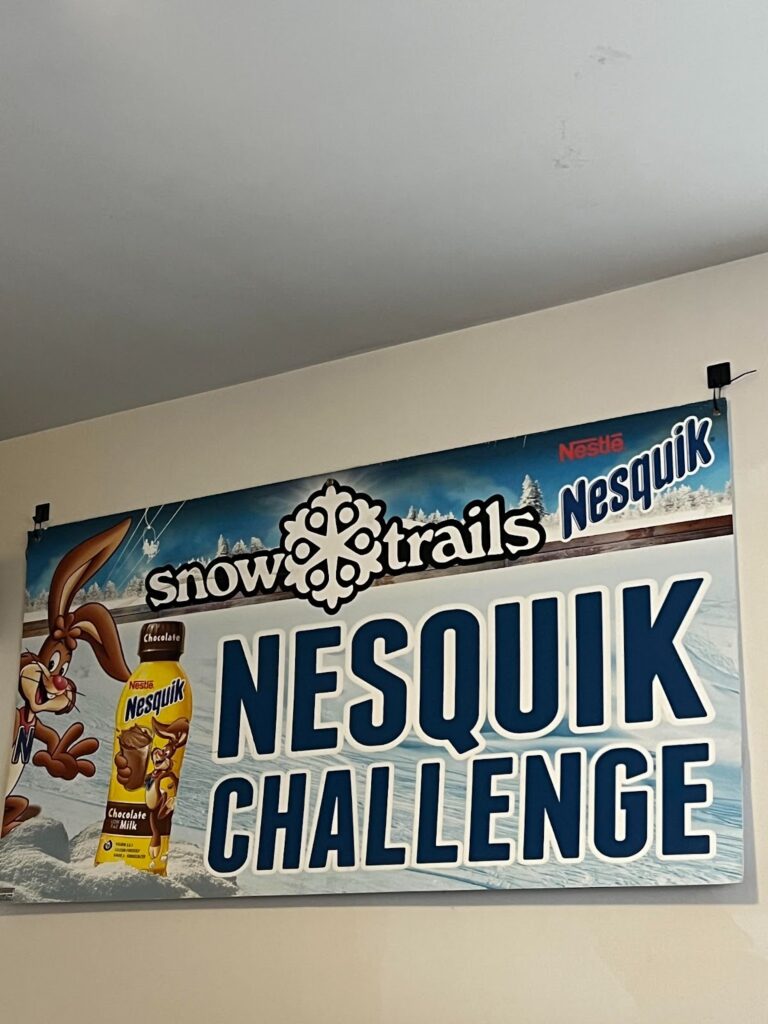 nesquik sign hanging on the wall