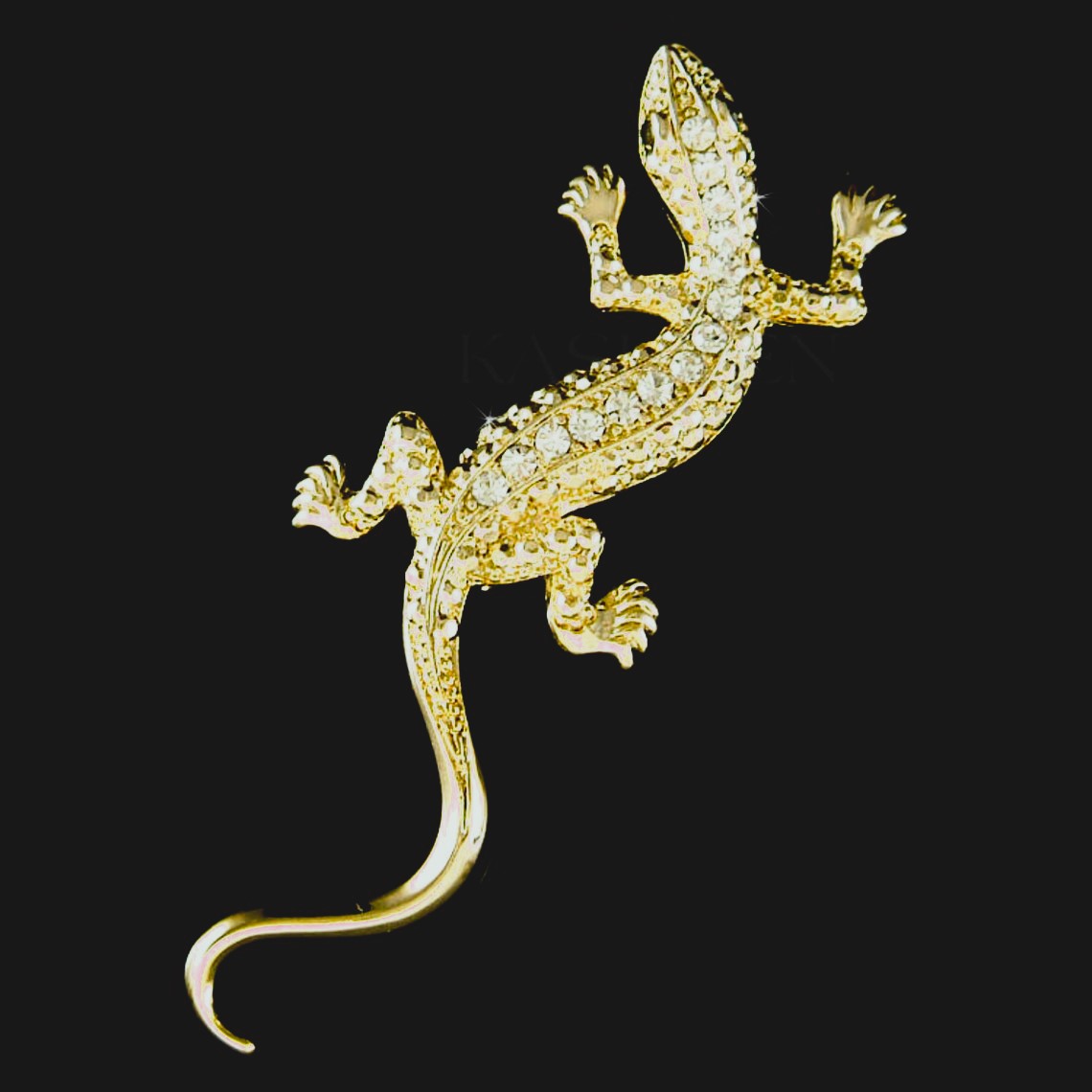A brooch/pin of a lizard that is gold