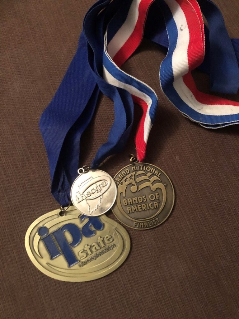 three medals on a wooden table