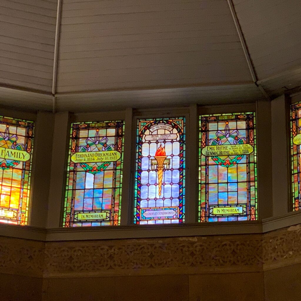 Interior photo of original chapel ceiling, showing original stained glass windows
