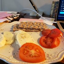 plate of tomatoes and mozzarella with wheat crackers